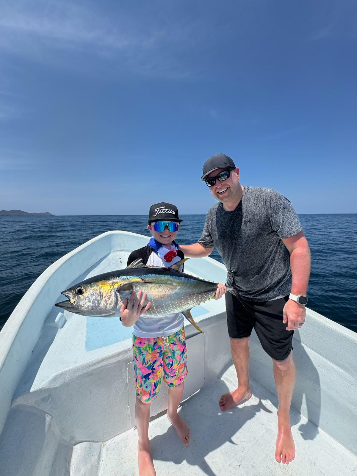 Father and son with yellowfin tuna on family fishing charter Playa El Jobo