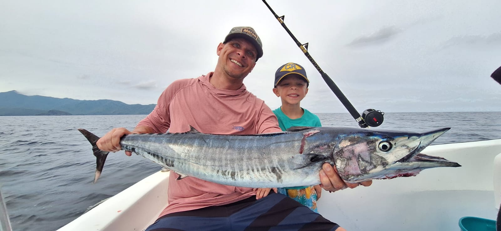 Father and son with wahoo on fishing charter