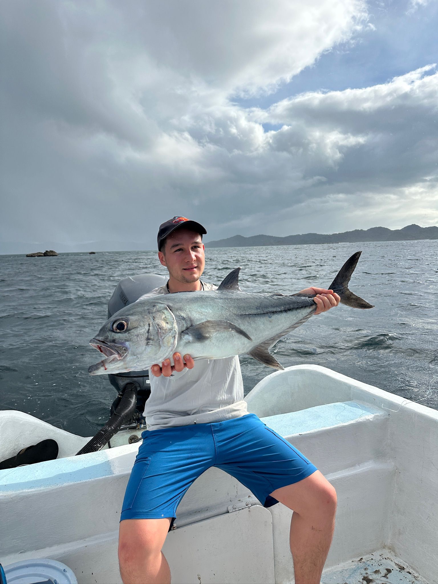Angler with trophy roosterfish on panga fishing charter Guanacaste Costa Rica