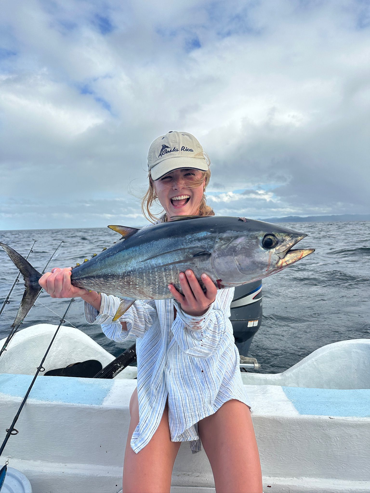 Young woman with yellowfin tuna on sport fishing charter Costa Rica