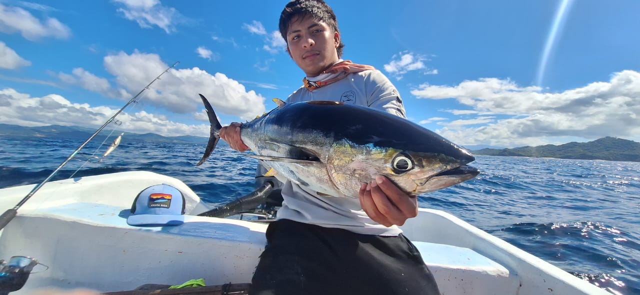 Crew member with yellowfin tuna caught offshore Guanacaste Costa Rica
