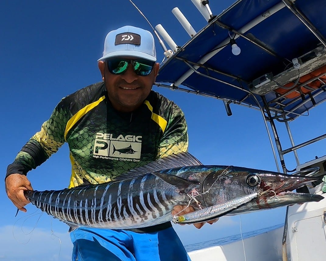 Captain with wahoo caught on deep sea fishing trip Guanacaste Costa Rica