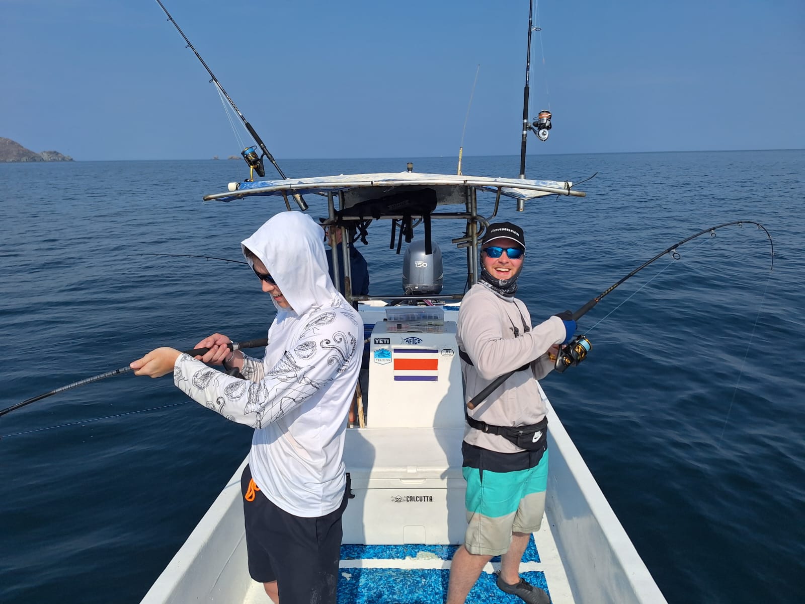 Two anglers fighting fish on sport fishing charter near Santa Elena Costa Rica