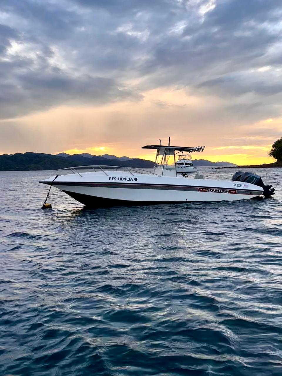 Resiliencia sport fishing boat docked at Playa El Jobo twin Yamaha outboards